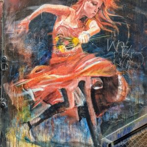 Street art of a women dancing holding flowers.