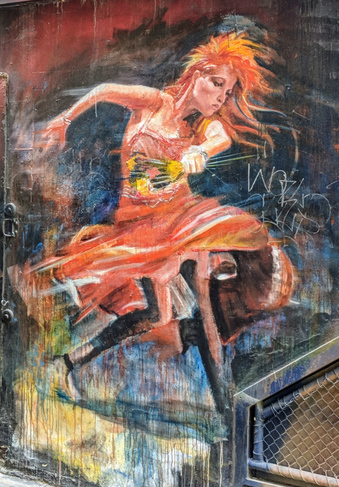 Street art of a women dancing holding flowers.