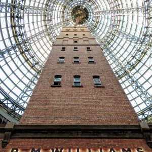 Photo of a brick tower underneath a metal and glass dome.