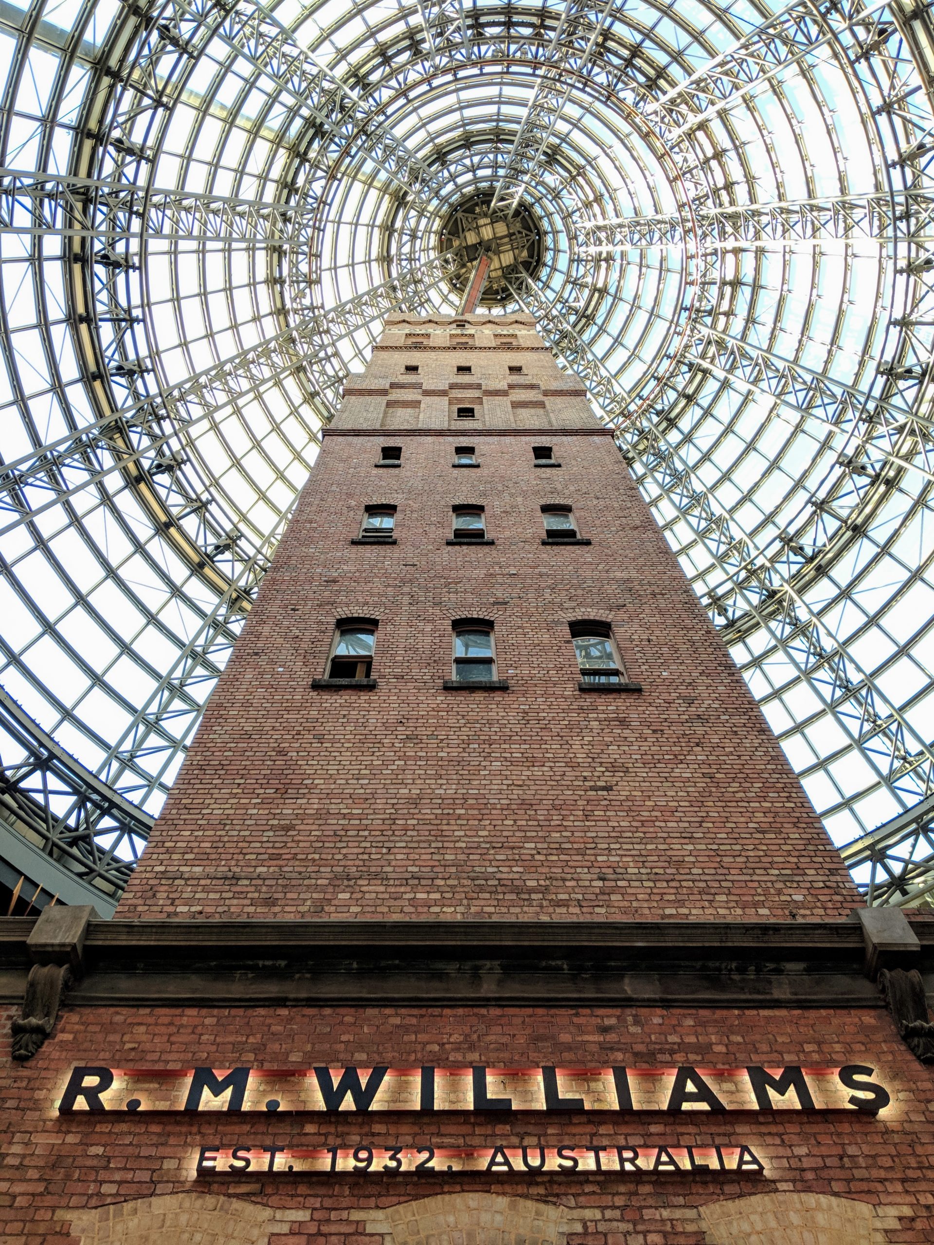 Photo of a brick tower underneath a metal and glass dome.