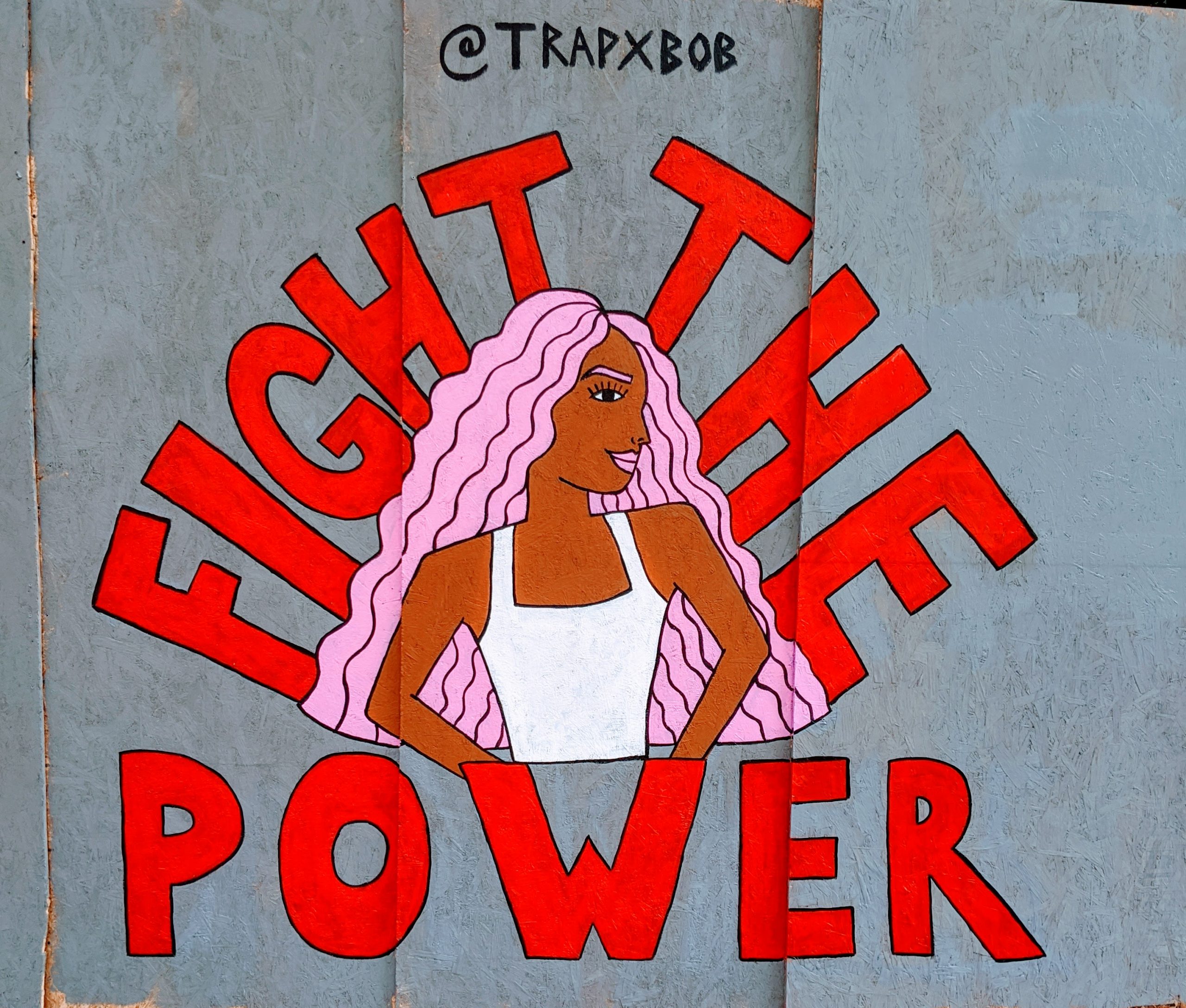 Photo of street art depicting a black women surounded by the words "Fight The Power"